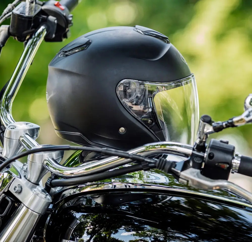 Black motorcycle helmet sitting on a bike