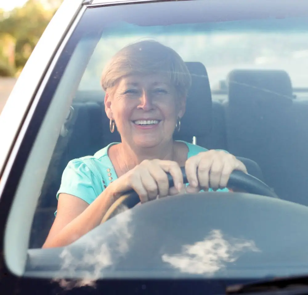 Woman Smiling while driving a car