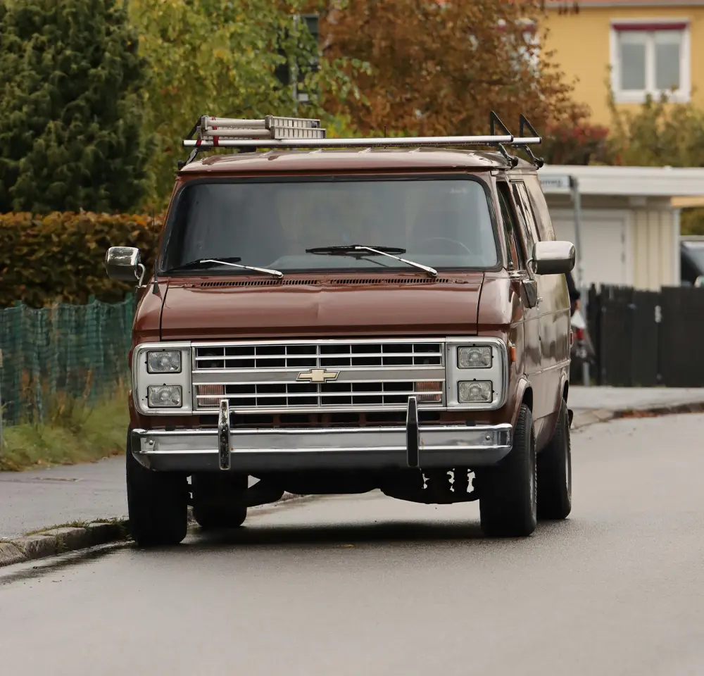 Vintage chevrolet van parked by the side of road